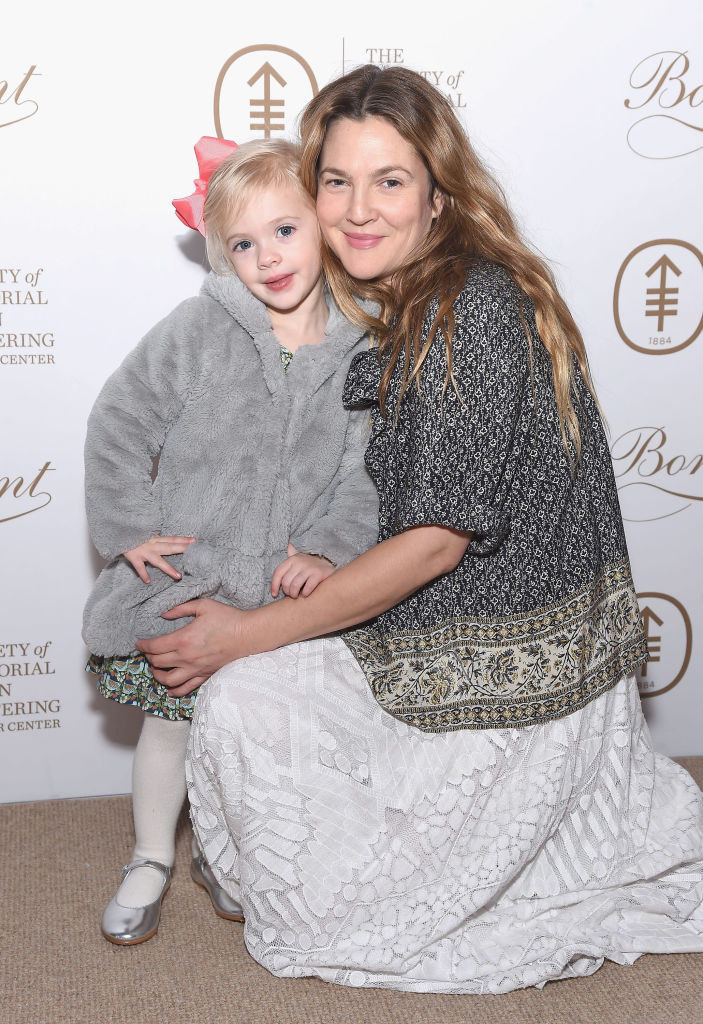 Drew posing at an event with one of her daughters