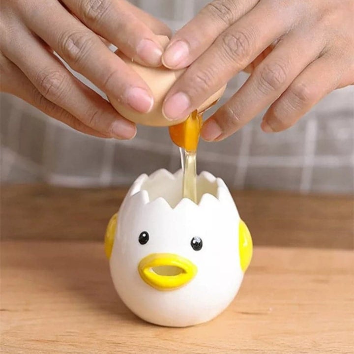 Model cracking egg into egg white separator