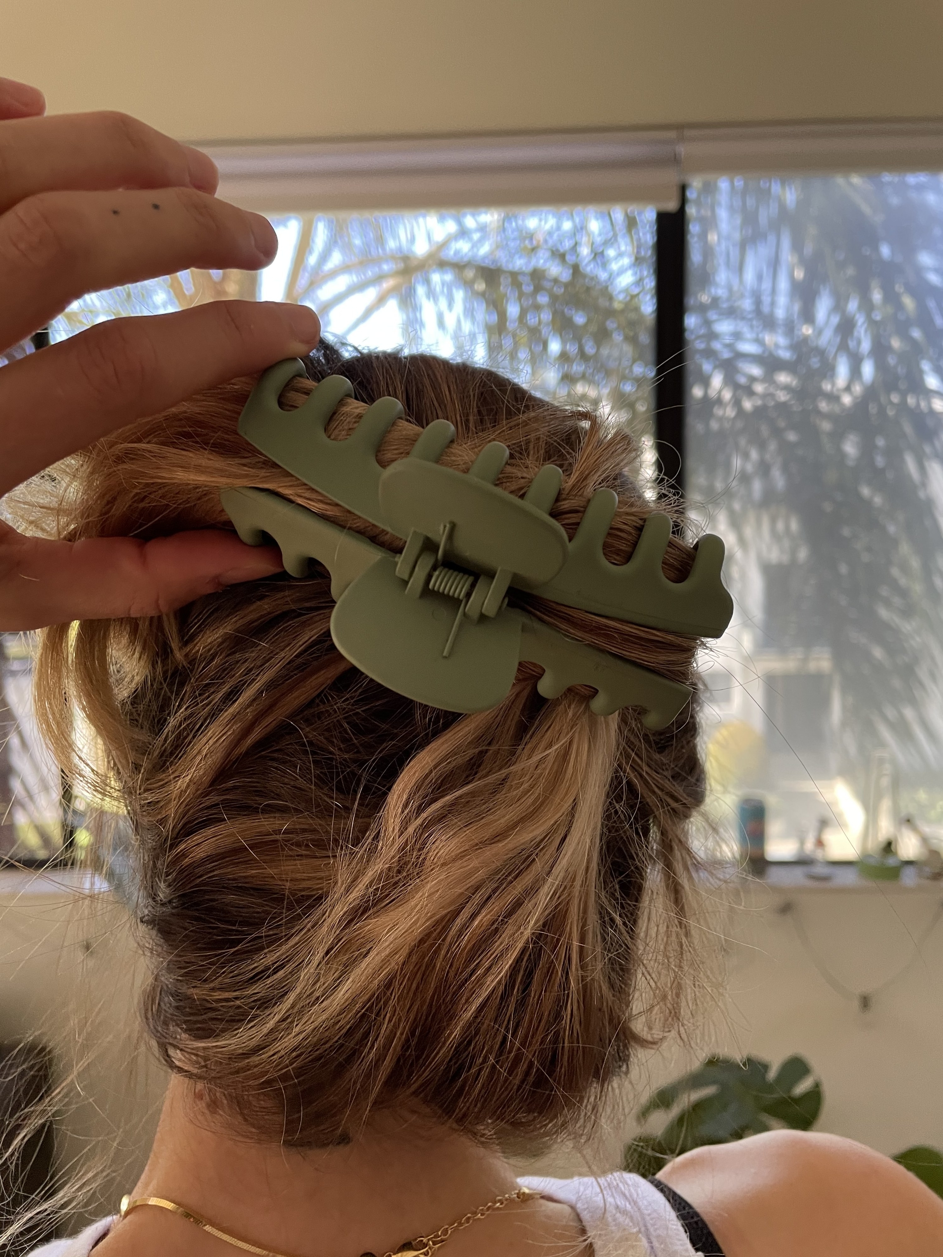 An image of the back of the author's head with her hair clipped with one of the big hair clips