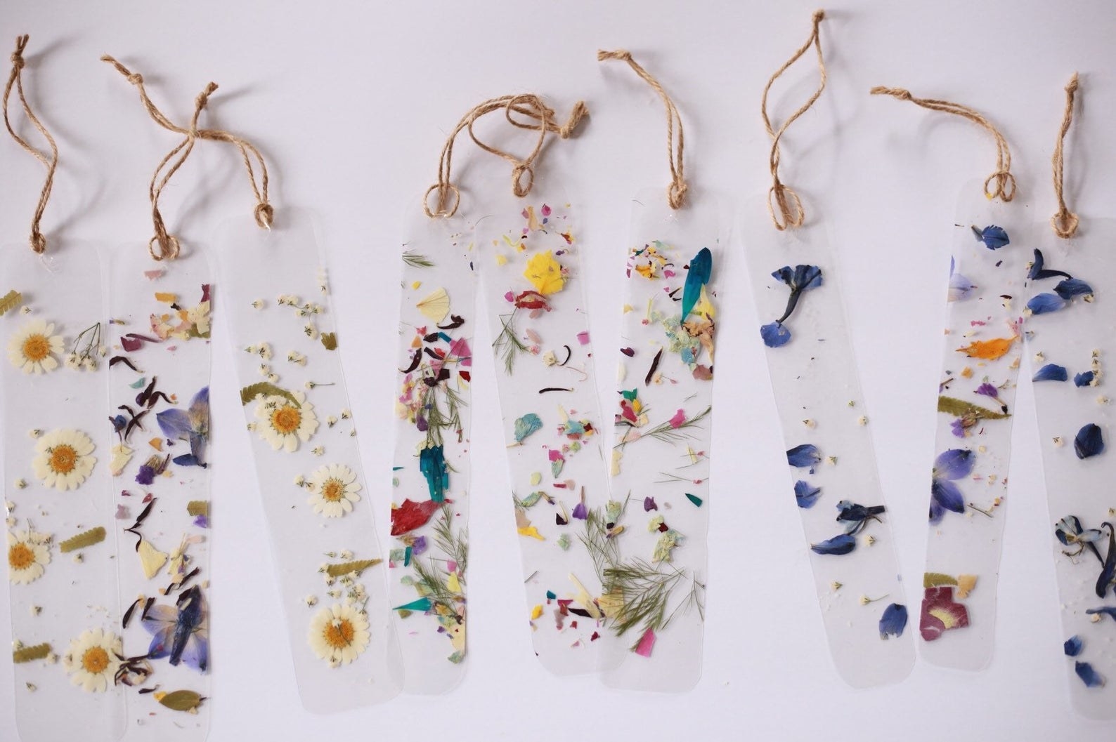 Transparent bookmarks with dried pressed flowers in them 