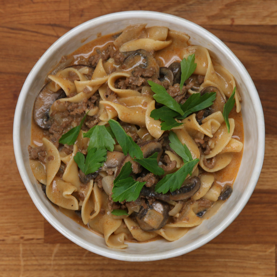 A top-down view of the beef stroganoff in a porcelain bowl