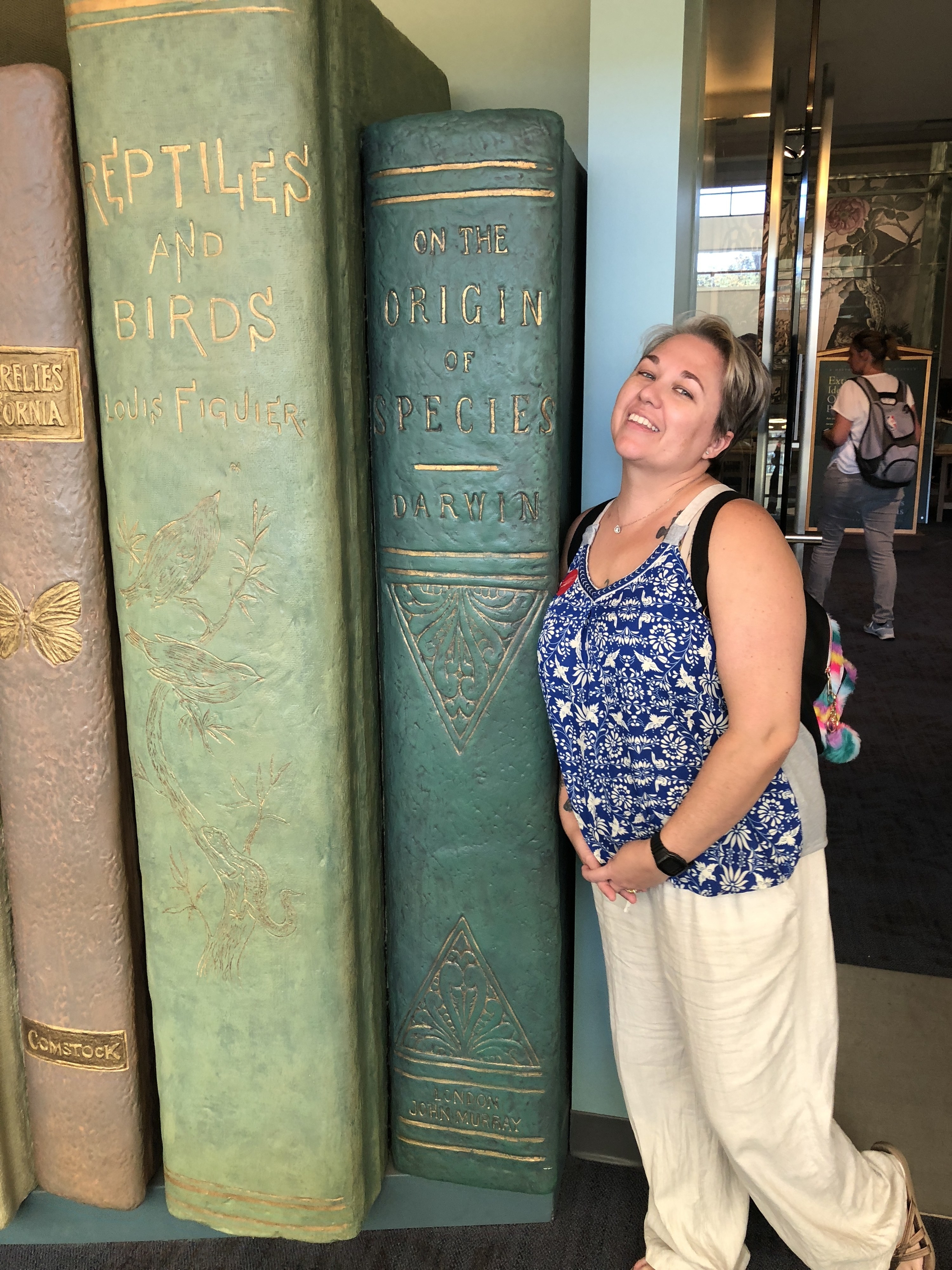 Cayce posing next to a set of giant books