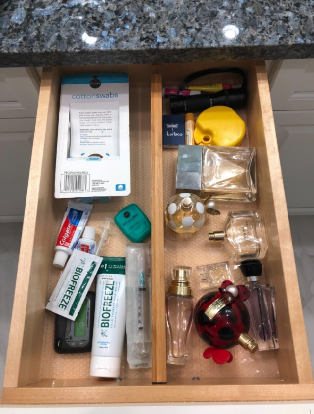reviewer image of divider added in to bathroom drawer to separate perfumes from toothbrush