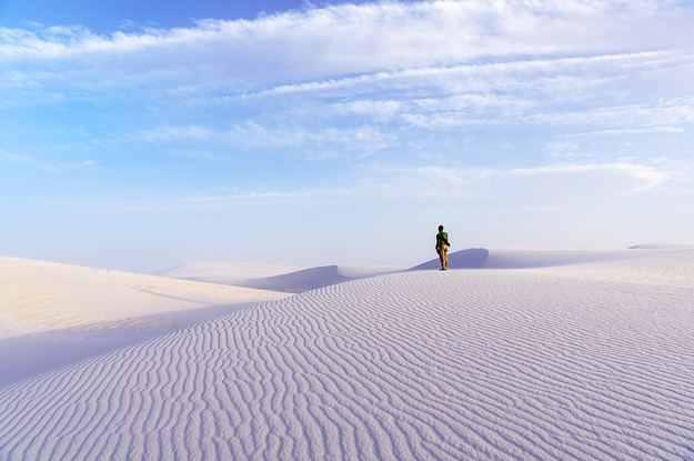 Person stands on perfectly white sand dunes