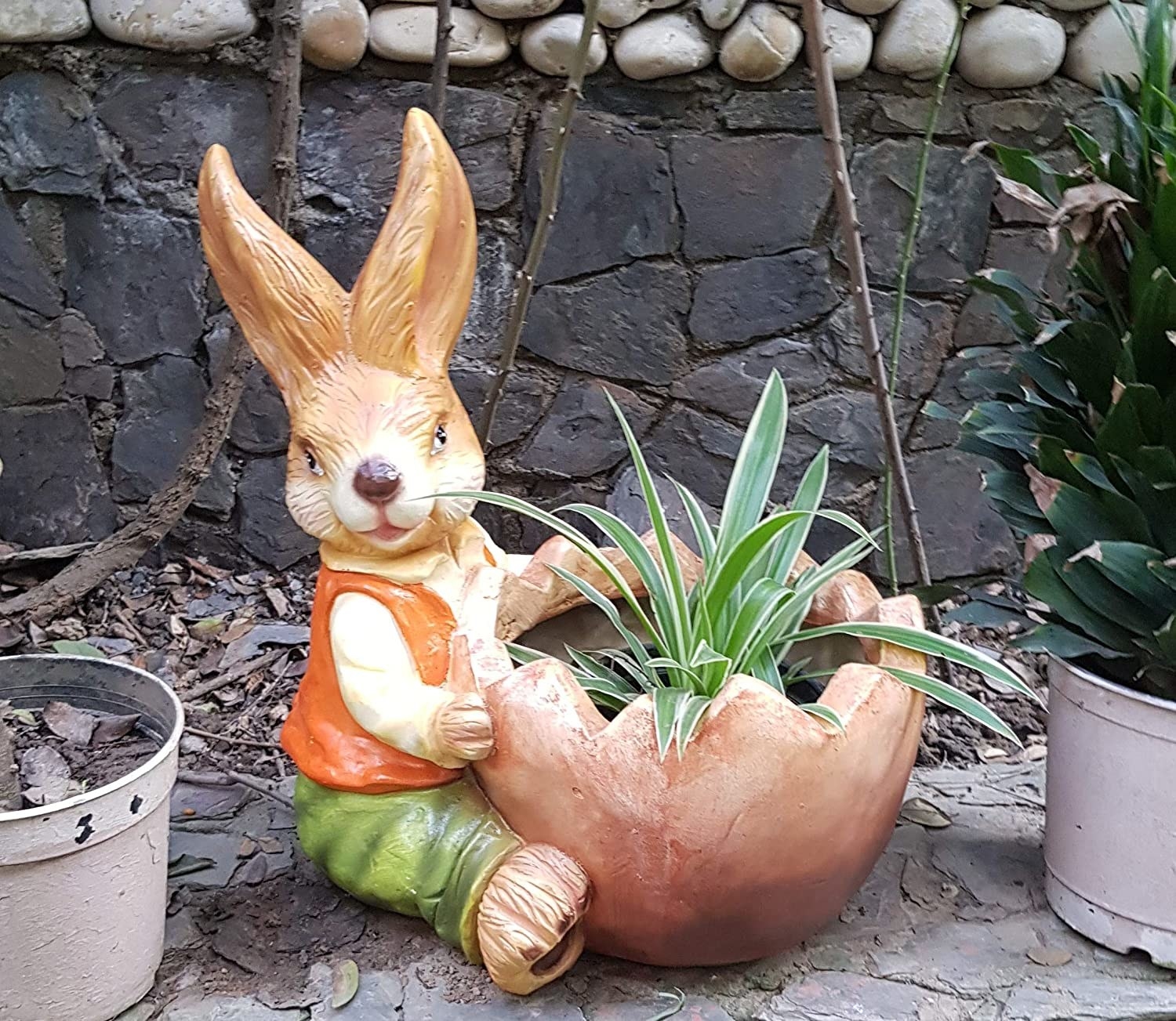 A planter in the shape of a bunny hugging a pot.