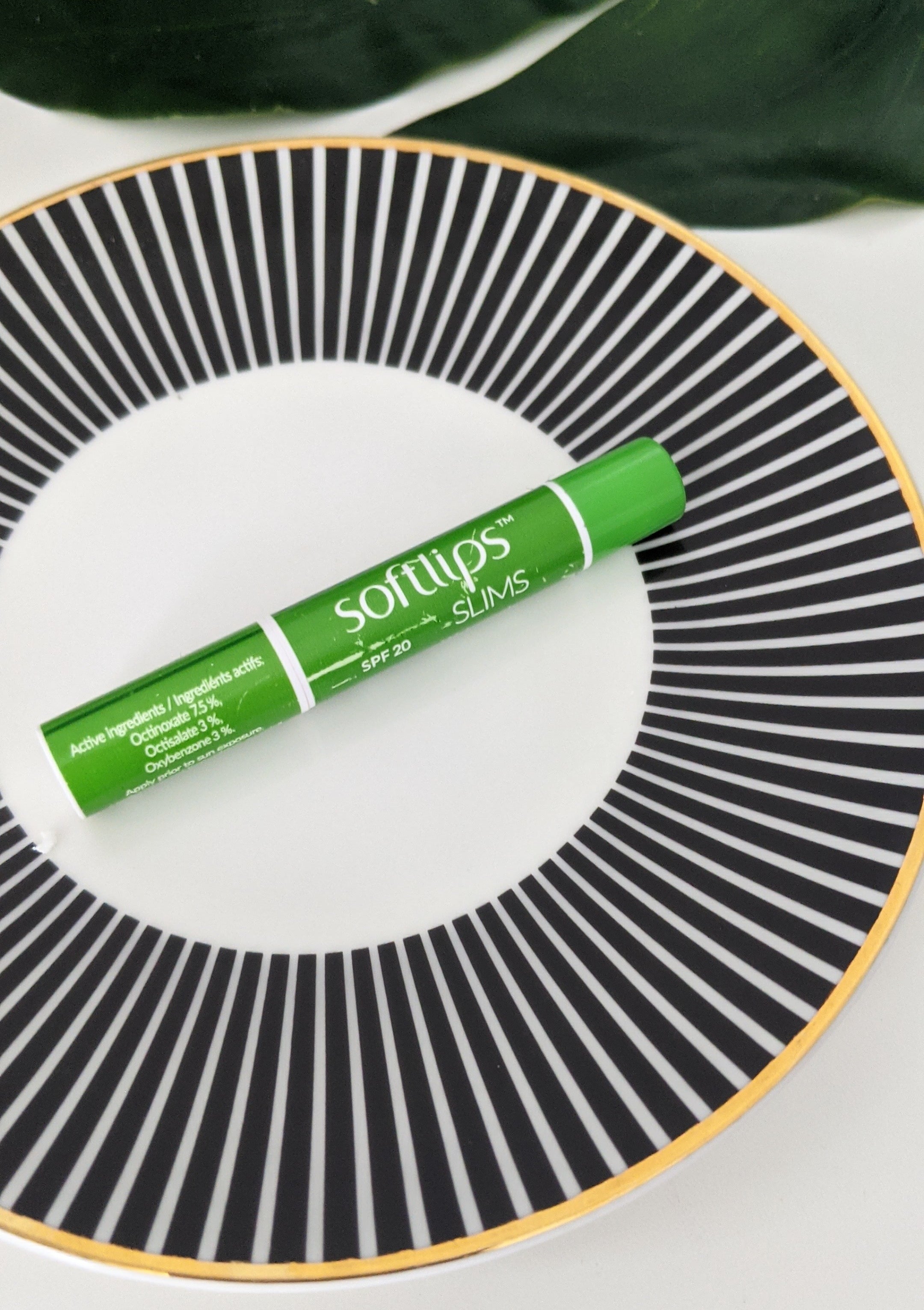 A small tube of lip balm on a plate