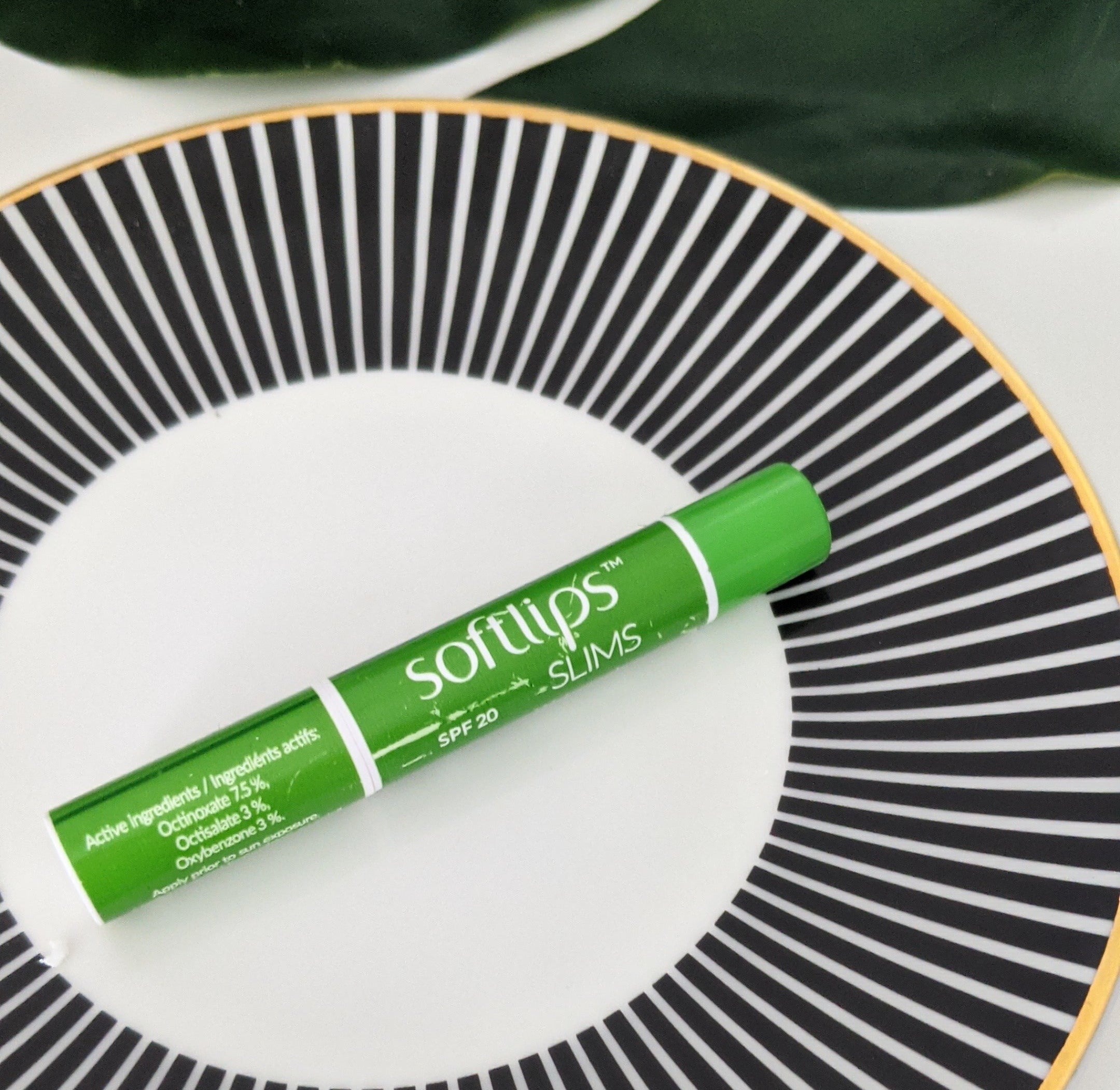 A small tube of lip balm on a plate