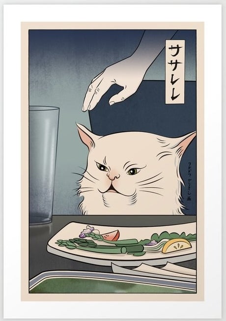 A cat sitting in front of a plate at a dinner table 