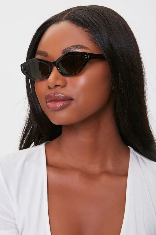 model wearing black cat-eye glasses