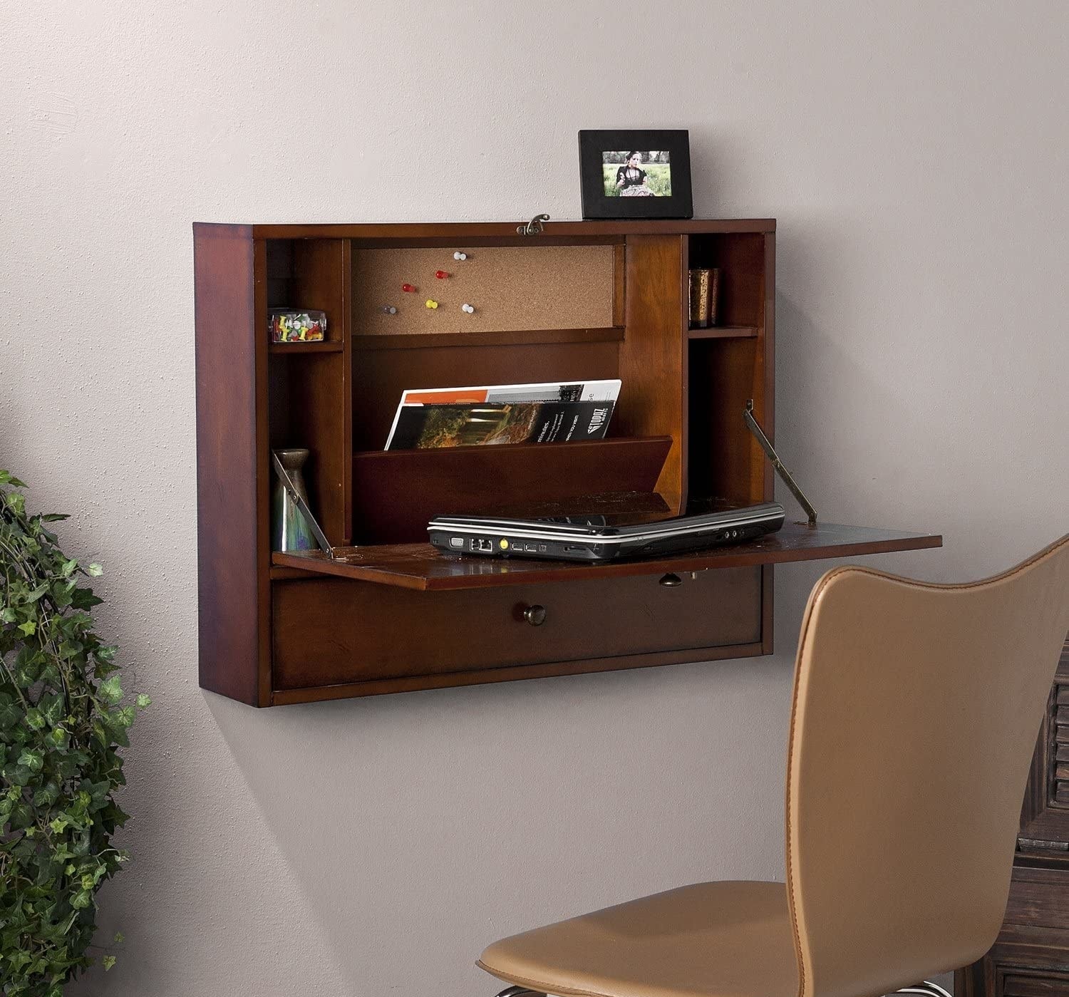 brown square attached to the wall with a table down, making it into a desk