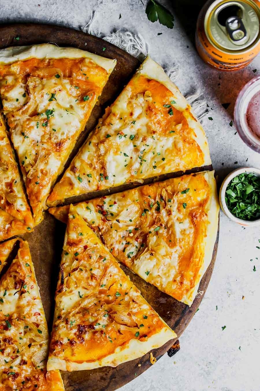 A pumpkin and gouda pizza cut into slices.