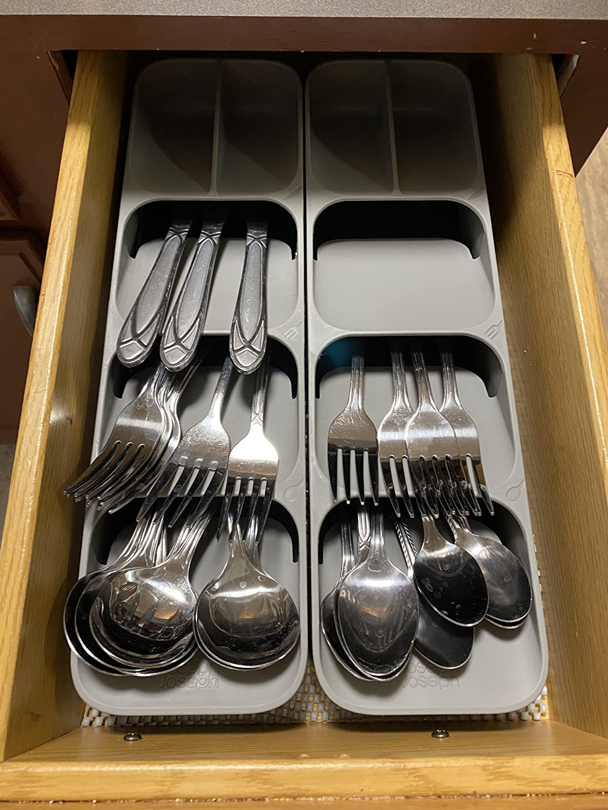 reviewer image of utensils organized in a kitchen drawer using the joseph joseph drawer organizer