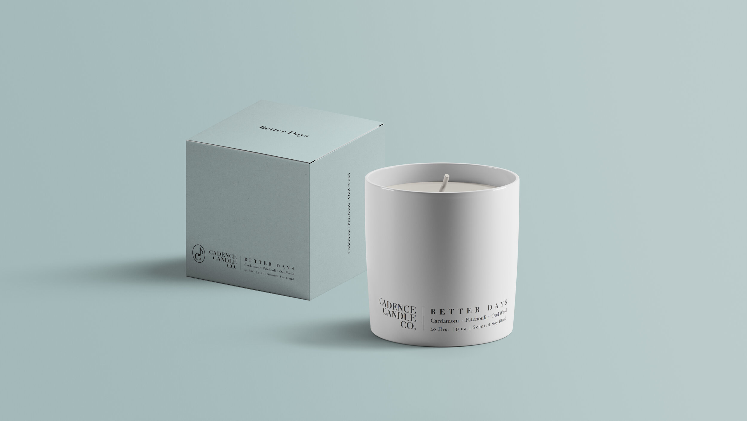 a white candle that says better days on it next to a pale blue box