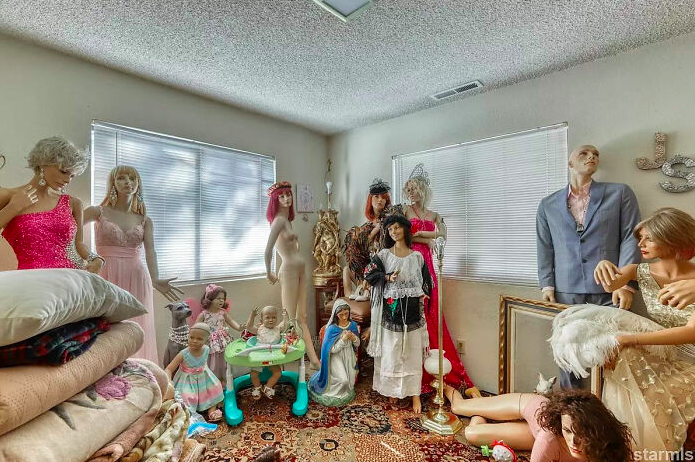 Several mannequins and dolls standing in a room