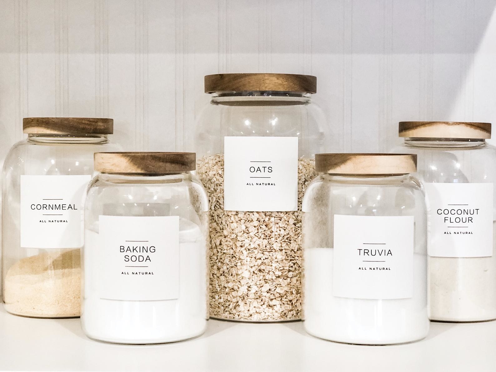 Cornmeal, baking soda, oats, truvia, and coconut flour labels on glass jars