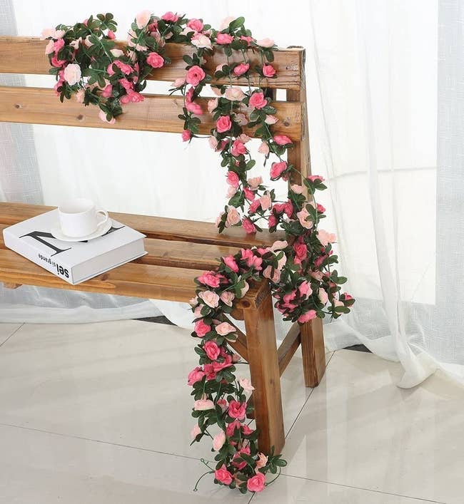 pink flower garland adorning an indoor bench 