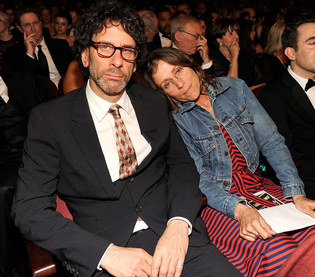 Joel Coen and Frances McDormand sit in the audience of an awards show