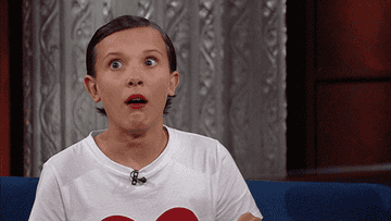 Millie Bobby Brown on The Late Show looking concerned and holding her head