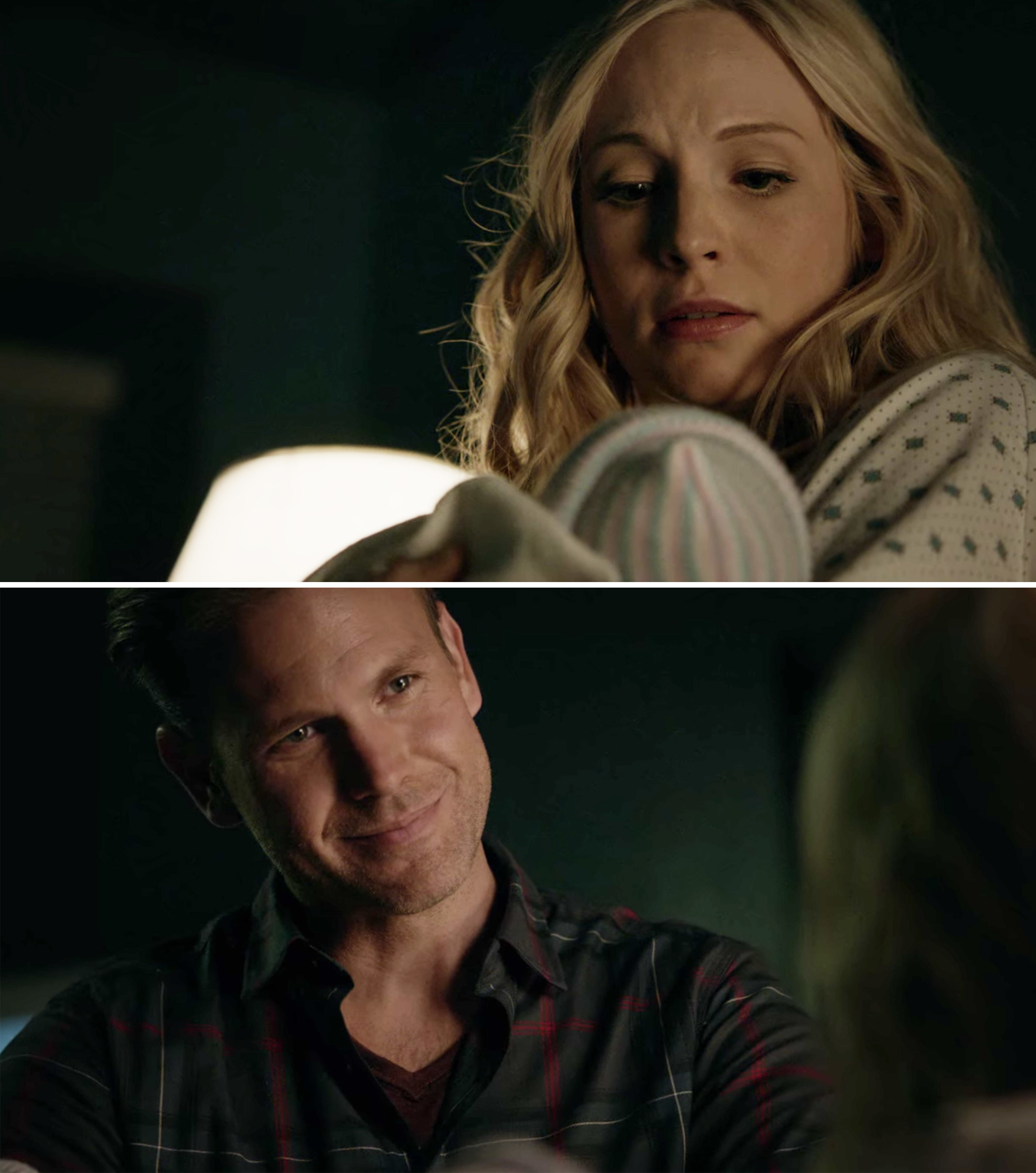 Caroline looking down at one of her twins and Alaric smiling at them