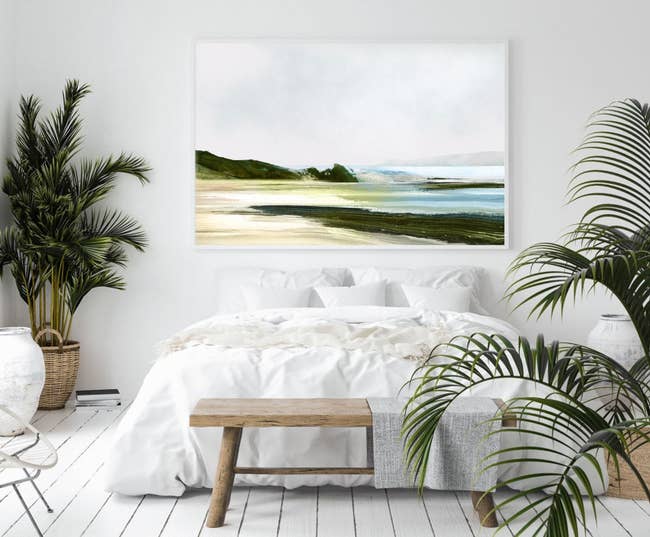large rectangle art print on the wall that looks like a screne beach scene
