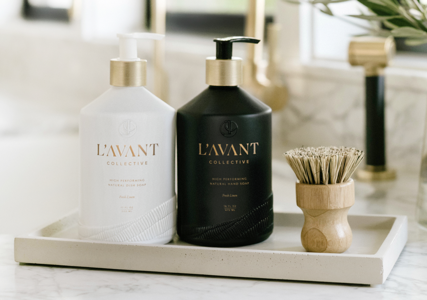A white pump bottle of dish soap sitting next to a matching black pump bottle of hand soap