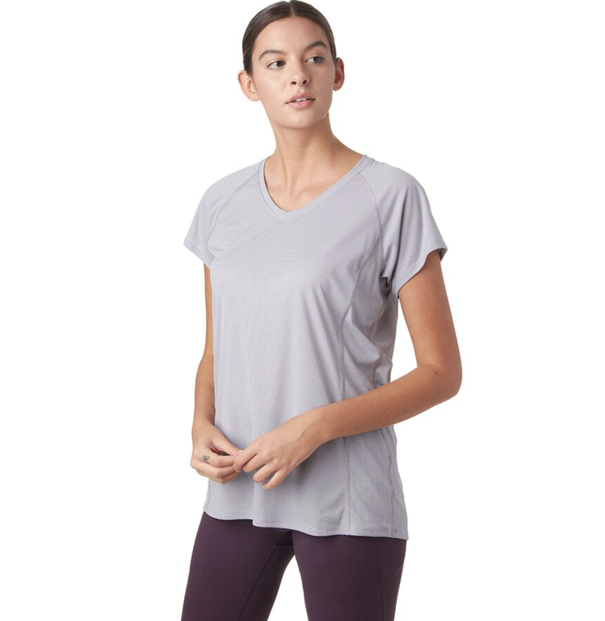 model in mauve short sleeve T-shirt and dark purple leggings