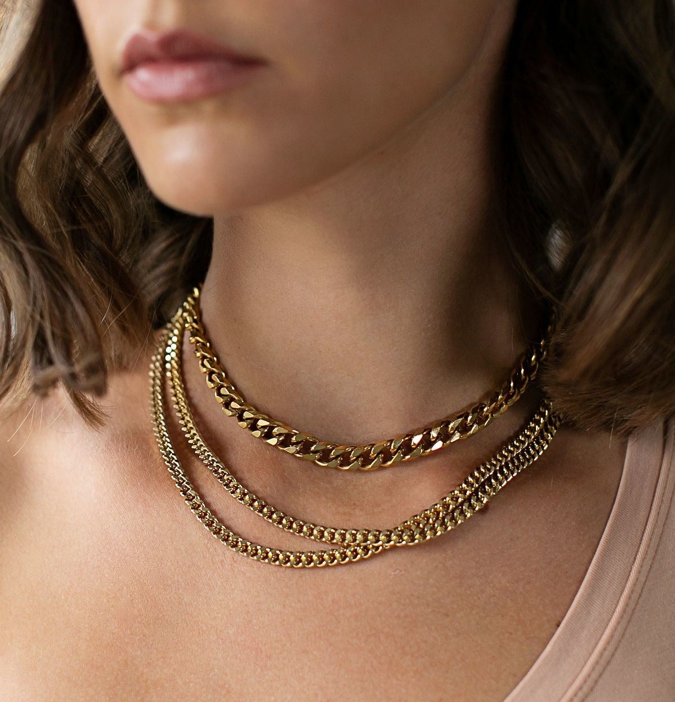 model wears thick gold chain 