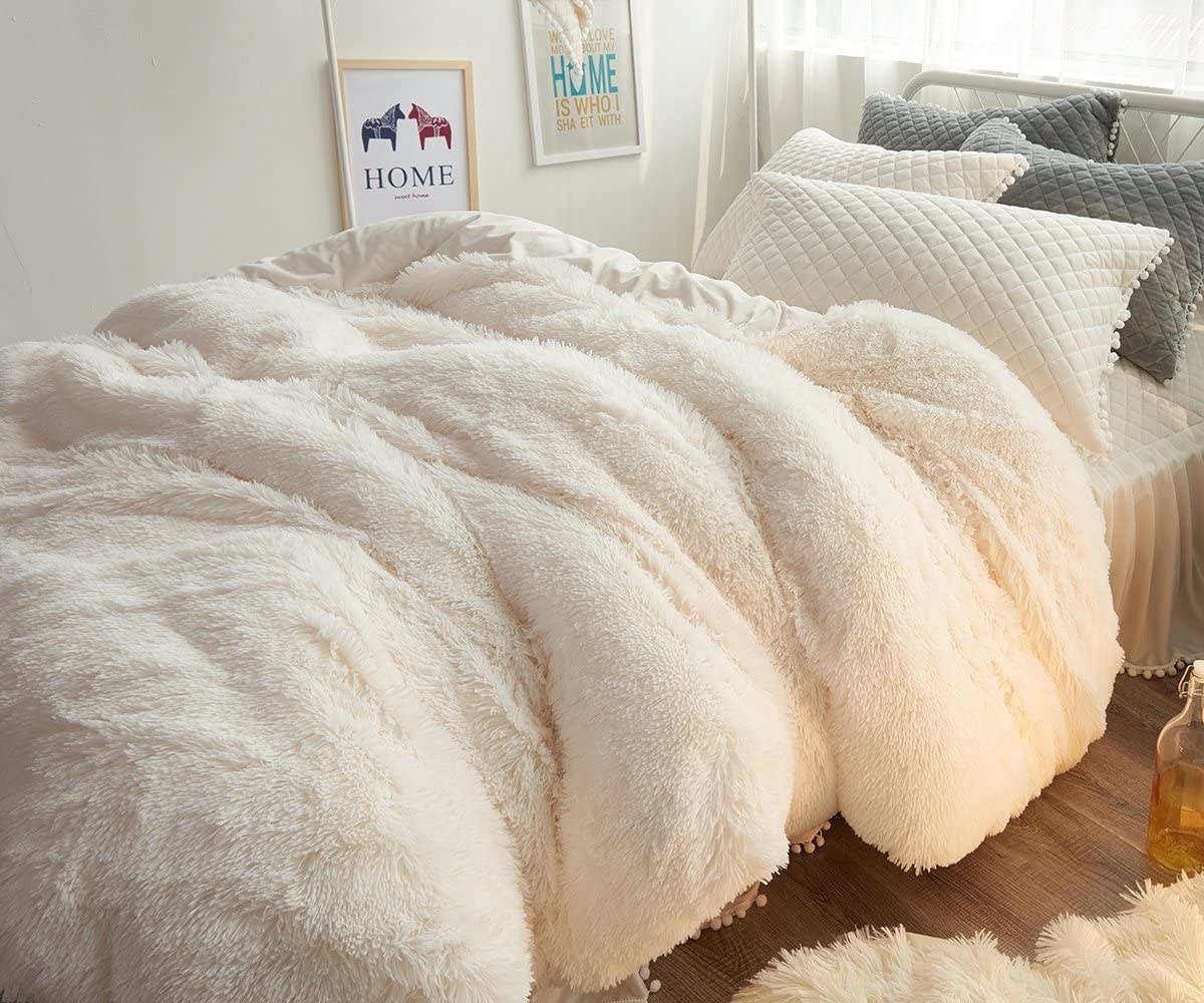 the fuzzy duvet cover on a bed