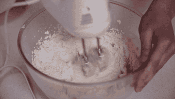 A person mixing their batter