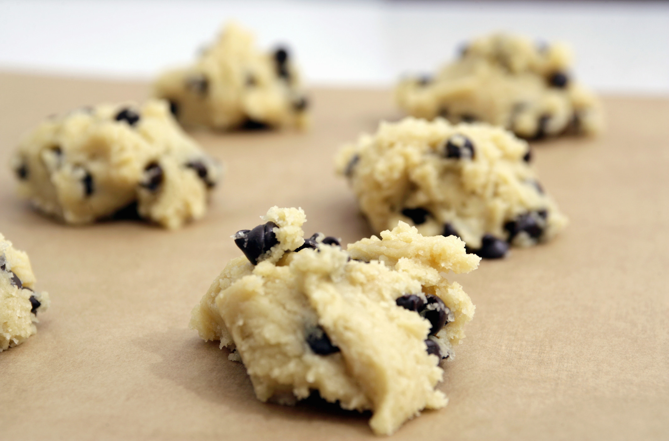 Chocolate chip cookie dough on a cookie sheet