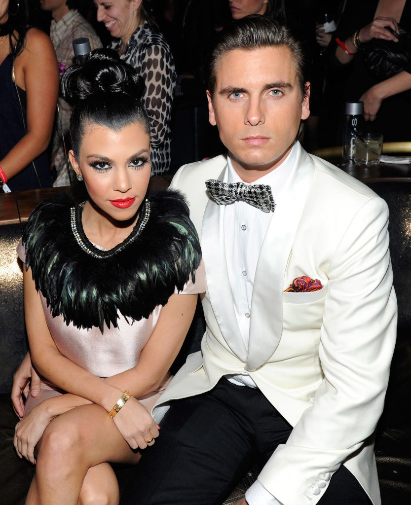 Kourtney Kardashian, wearing a satin and feathered dress, and Scott Disick, wearing a tux, attend the launch of AG Adriano Goldschmied&#x27;s &quot;backstAGe presents:&quot;