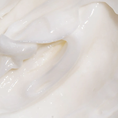 Close up showing the consistency of the thick white hair mask