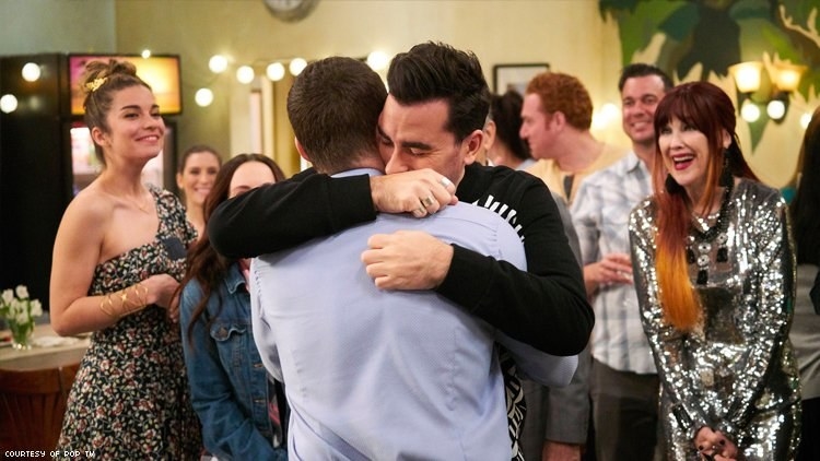 david hugging a man infront of his friends and familt