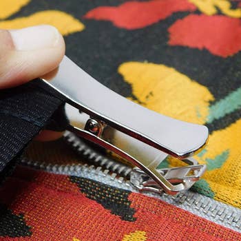Zipper puller fastening to a garment zipper