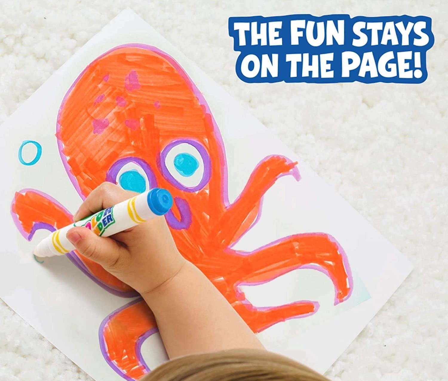 A child's hand colouring a picture of an octopus on a paper