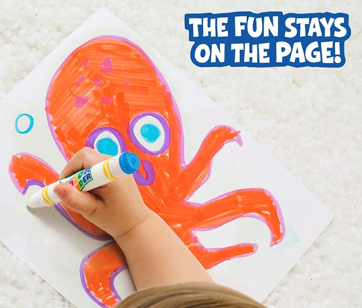 A child&#x27;s hand colouring a picture of an octopus on a paper