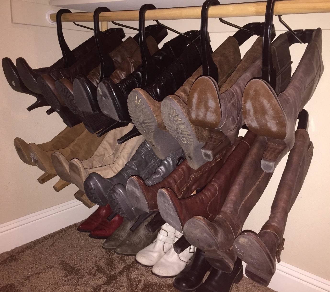 reviewer image of a bunch of boots hanging, taking up less space