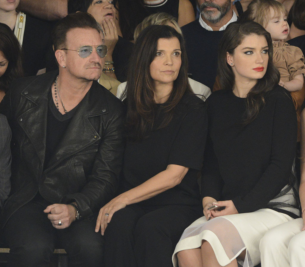 Eve and her parents sitting in the audience of a runway show