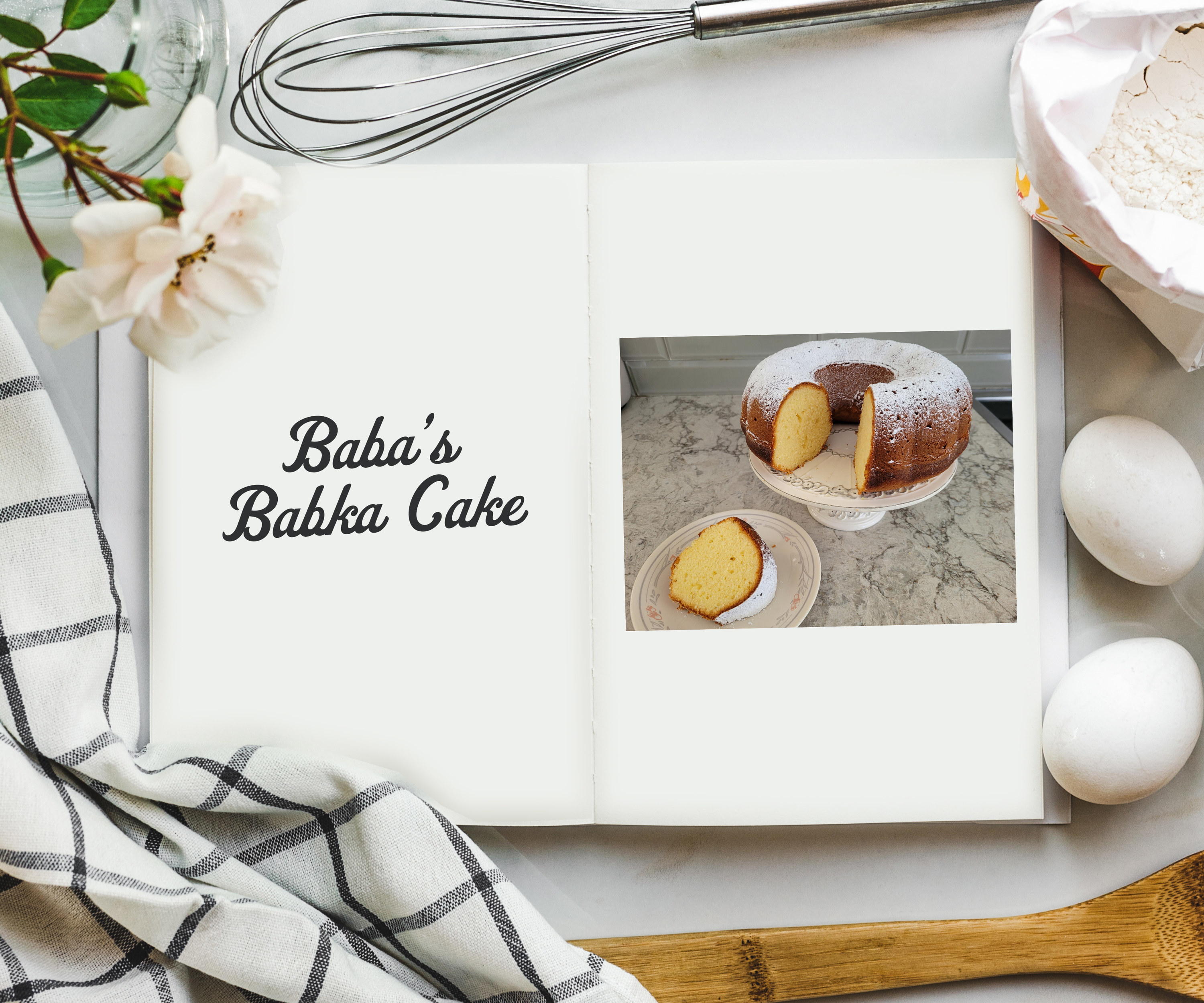 An overhead shot of cookbook on a table surrounded by ingredients and a photo on the inside with a photo of a dark brown bundt take on a stand with a piece nearby on a plate.