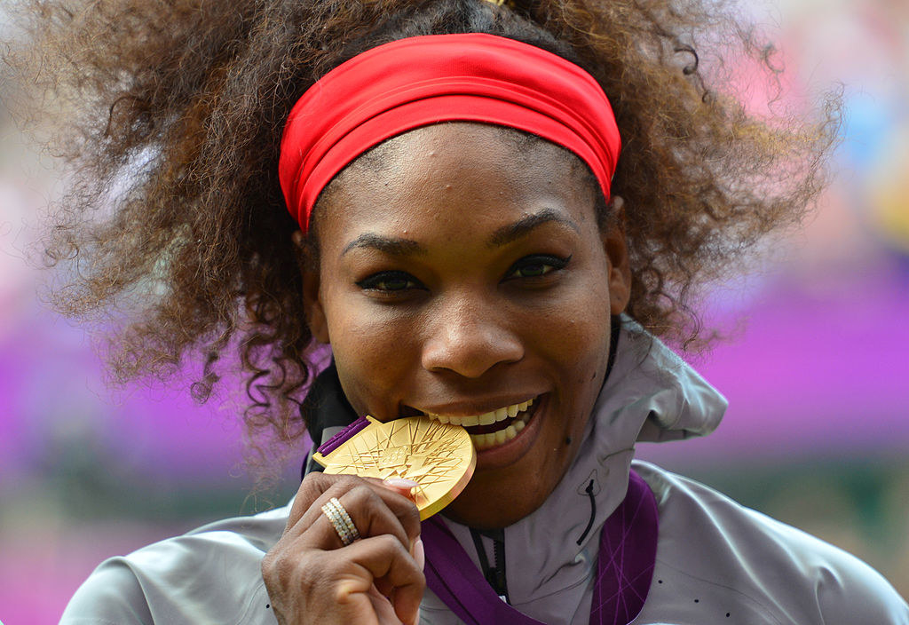 Serena Williams poses on the podium with her gold medal after defeating Russia&#x27;s Maria Sharapova in the women&#x27;s singles gold medal match