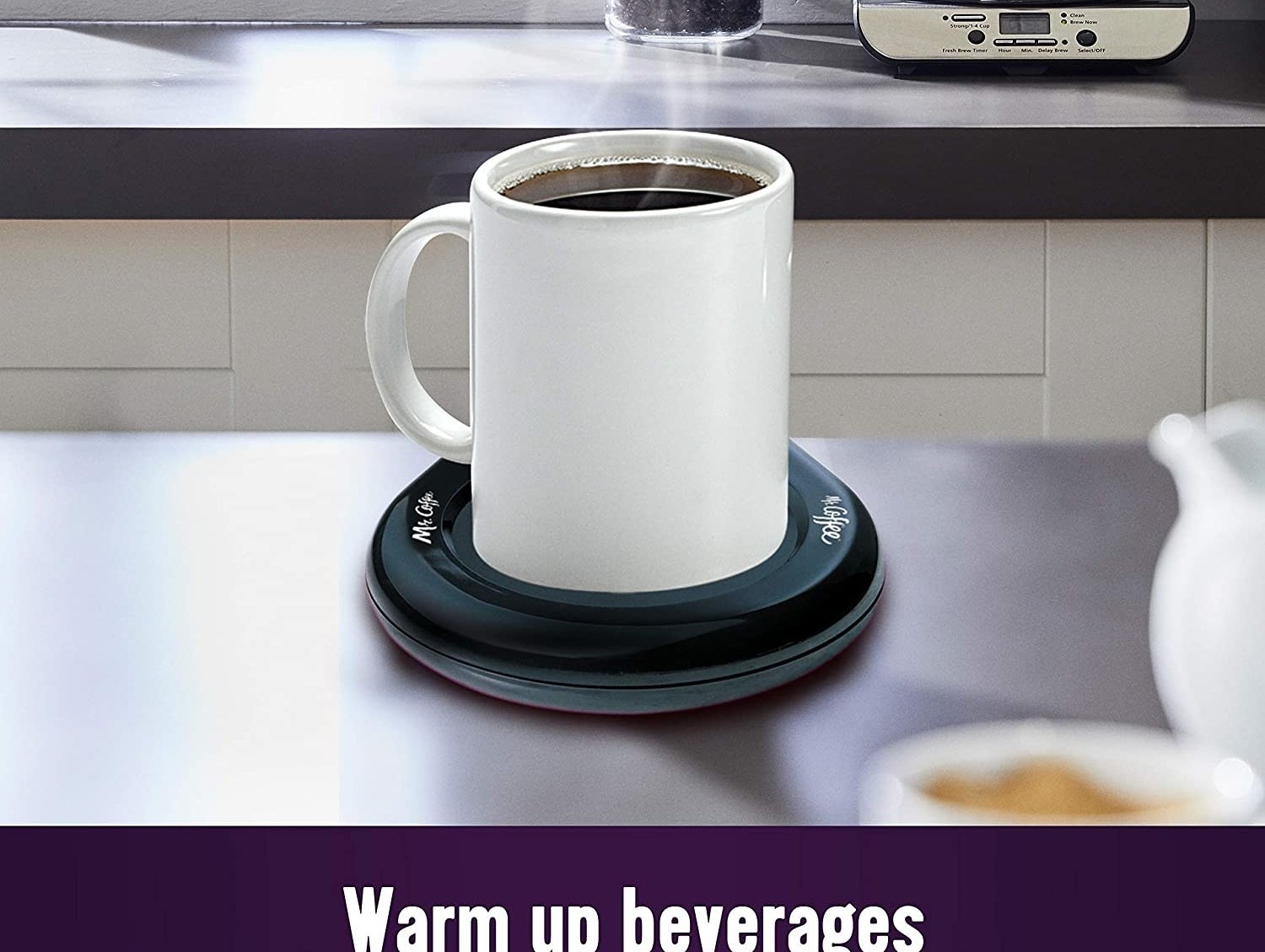 Mug propped on black circular warmer on table 