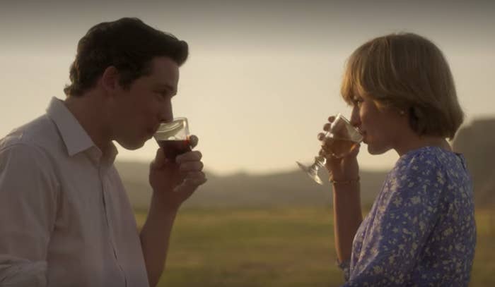 A young Charles and Diana sipping on drinks 