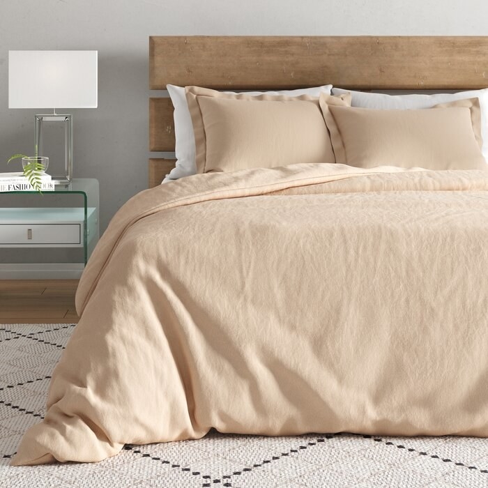 Almond color bedding that hits the floor 