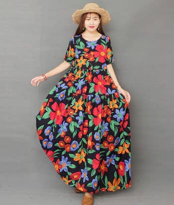 model in large long dress with colorful flowers 