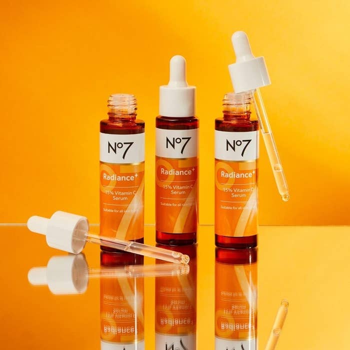 bottles of the vitamin C serum styled on a mirror