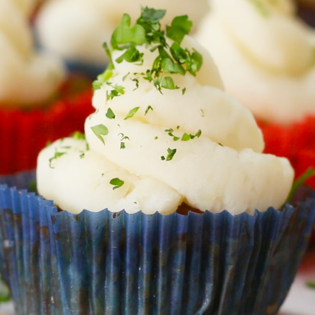 A close up of the meatloaf cupcakes topped with mashed potato icing
