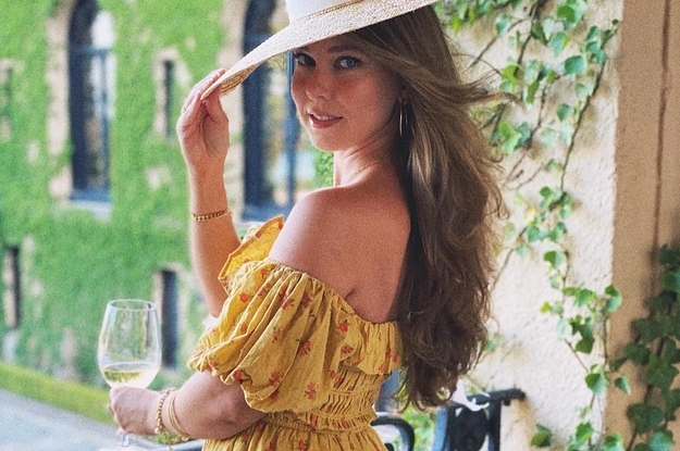 reviewer wearing off the shoulder dress with puffy sleeves and red flowers