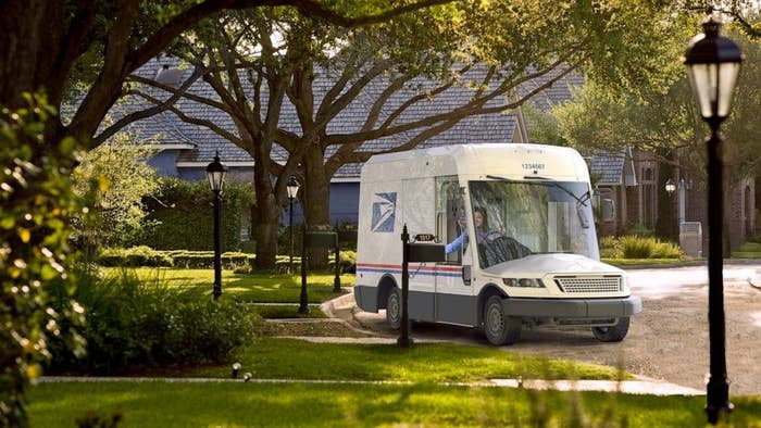 The new mail truck which has a large glass front window and a cartoon-ish shape