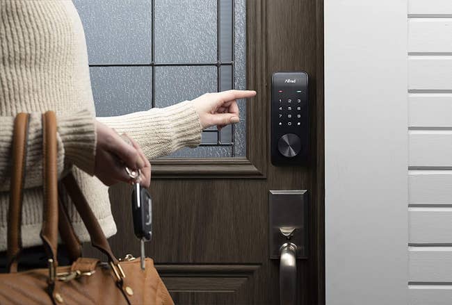 a model stepping up to the smart door lock touchpad