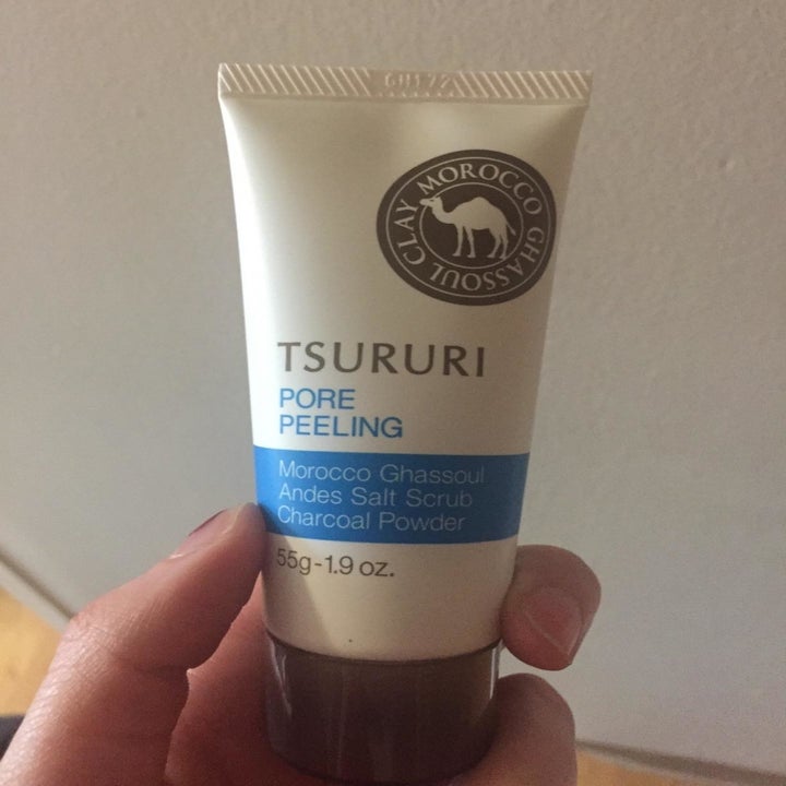 Reviewer holding the tube of product